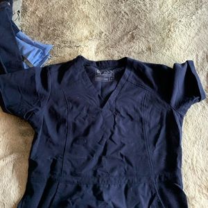 Various styles of navy Figs scrubs
